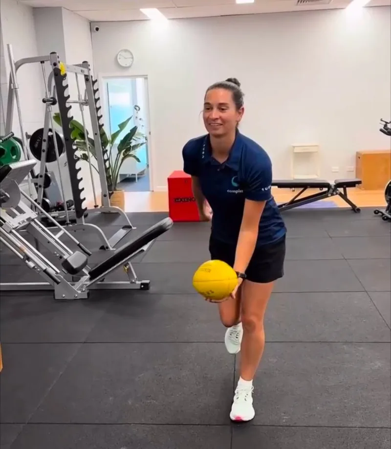 Physiotherapist Emma Draffin demonstrating a football rehabilitation exercise in the Complete Physio Richmond gym