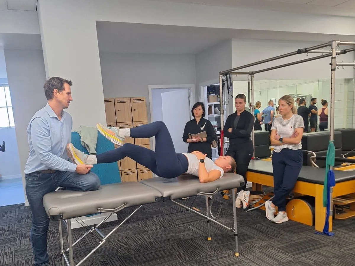 Prof Christian Barton conducting a clinical assessment at Complete Physio Richmond