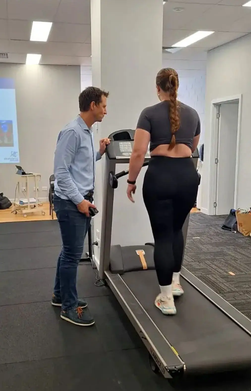 Prof Christian Barton assessing a runner's technique on a treadmill at Complete Physio Richmond