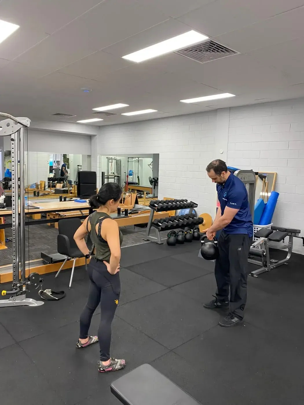 Strength and conditioning coach James Ross demonstrating safe lifting technique at Complete Physio Richmond