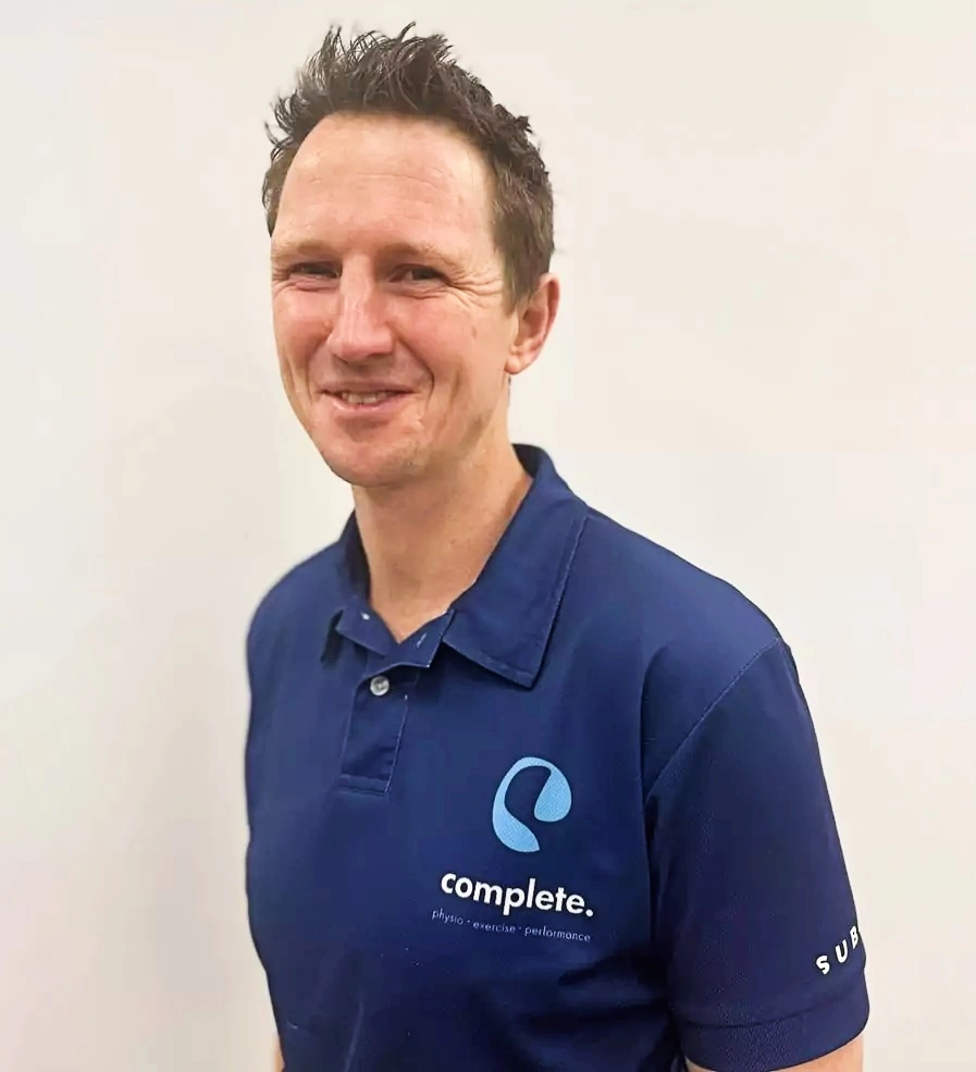 Portrait of physiotherapist Christian wearing a Complete Physio polo shirt.