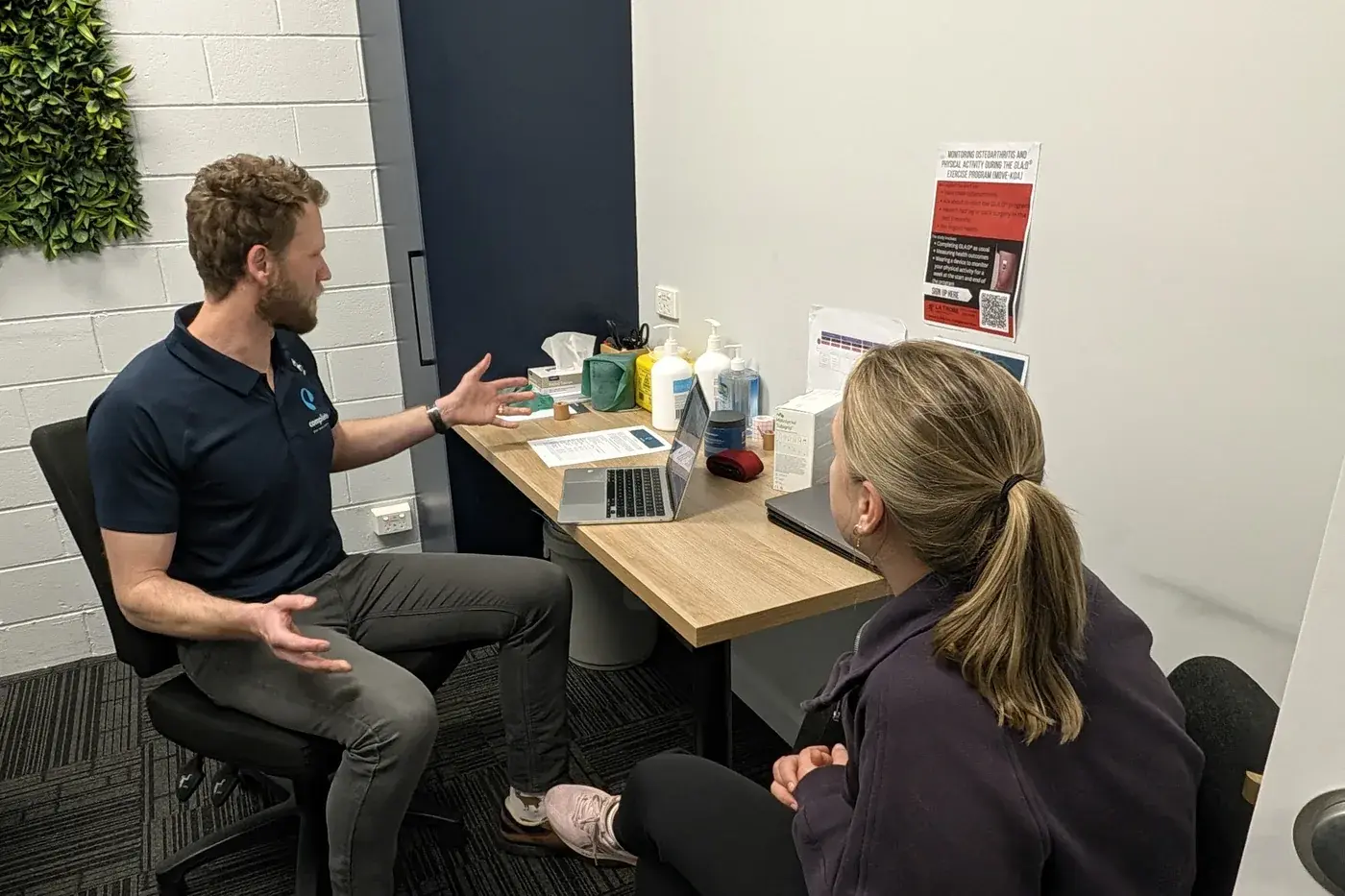 Physiotherapist talking through a treatment plan with a patient at Complete Physio Richmond.